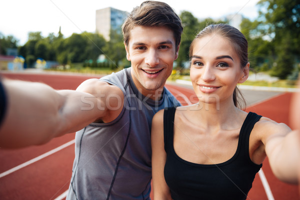 Young couple making selfie photo on stadium Stock photo © deandrobot