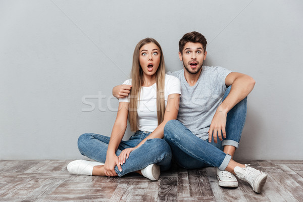 Fashion portrait of astonished couple Stock photo © deandrobot