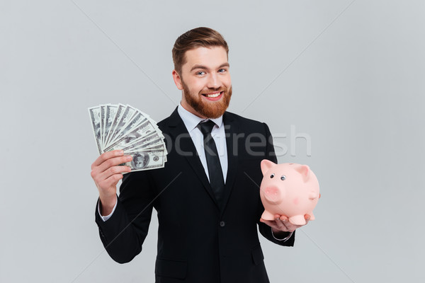 Business man with money and moneybox Stock photo © deandrobot