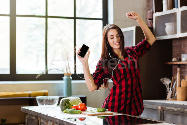 Woman dancing in kitchen Stock photo © deandrobot