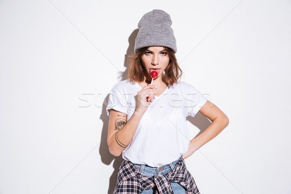 Young beautiful lady holding candy. Stock photo © deandrobot