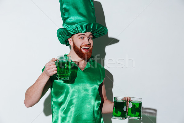 Happy bearded man in green costume Stock photo © deandrobot
