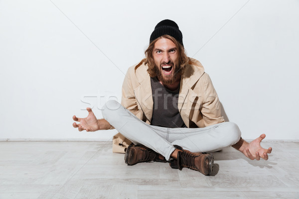 Portrait of a screaming angry hipster guy Stock photo © deandrobot