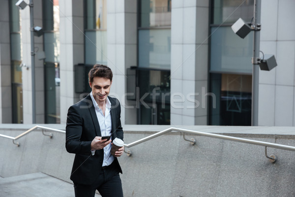 Man using phone and drinking coffee Stock photo © deandrobot