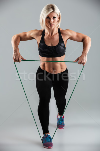 Full length portrait of a serious muscular adult sportswoman Stock photo © deandrobot