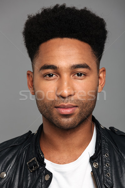 Close up portrait of a young african man with stubble Stock photo © deandrobot