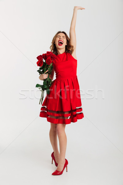 Full length portrait of a cheerful young woman Stock photo © deandrobot