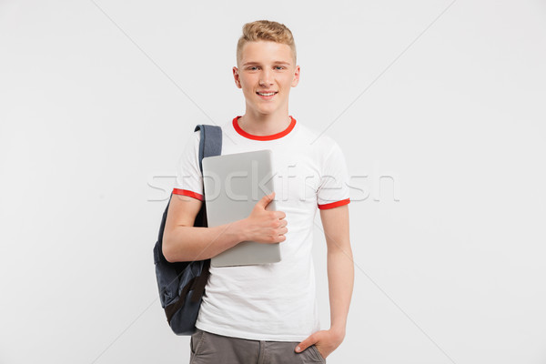 Image of teenager guy 16-18 years old wearing casual clothing an Stock photo © deandrobot