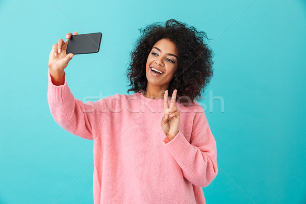 Portrait of gorgeous young woman making selfie on her smartphone Stock photo © deandrobot
