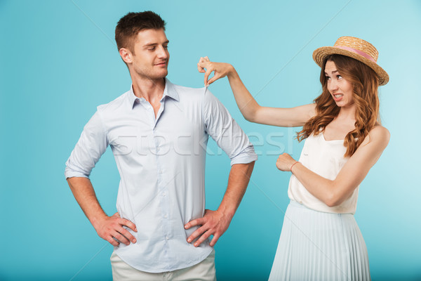 Young caucasian woman displeased because of man's shirt Stock photo © deandrobot