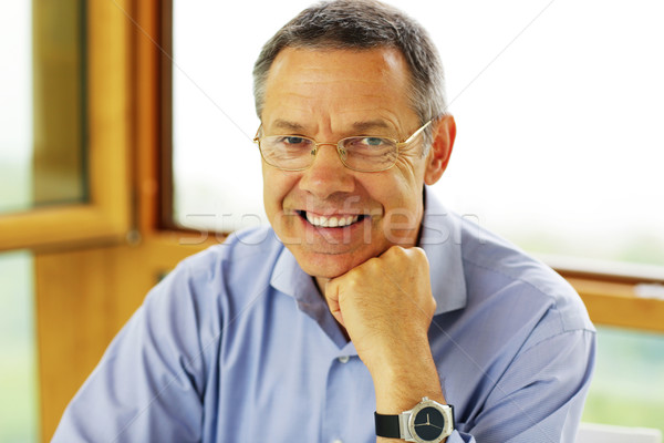 Portrait of a man with grey hair looking to the camera Stock photo © deandrobot