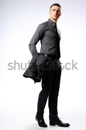 Full-length portrait of a confident businessman isolated on a white background Stock photo © deandrobot