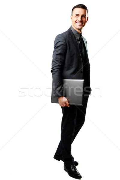 Full-length portrait of a businessman standing with laptop isolated on a white background Stock photo © deandrobot