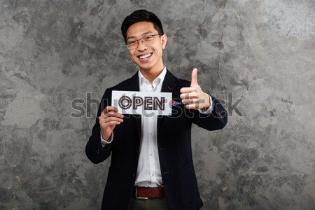 Happy businessman looking at watch over white background Stock photo © deandrobot