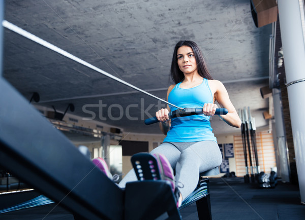 Stock photo: woman working out on training simulator at gym