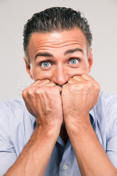Portrait of a frightened man looking at camera Stock photo © deandrobot
