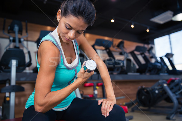 Girl workout with dumbbell on the bench Stock photo © deandrobot