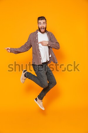 Excitado feliz joven saltar ejecutando Foto stock © deandrobot
