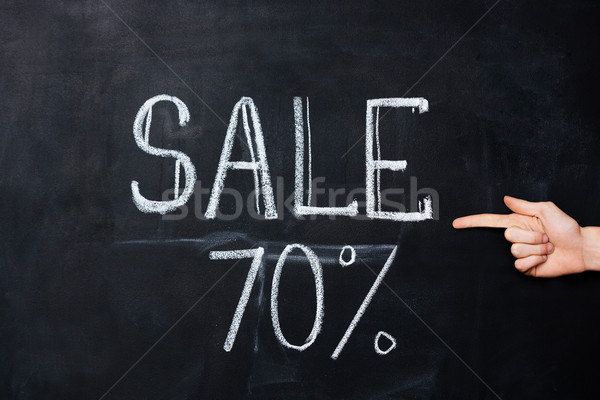 Hand pointing at seventy percent sale drawn on blackboard  Stock photo © deandrobot