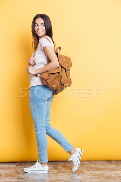 Full length portrait of a charming woman with backpack Stock photo © deandrobot