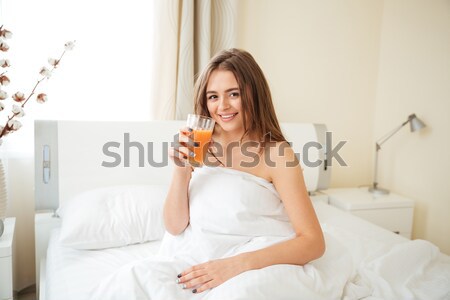 Stock photo: Woman making selfie photo on the bed at home