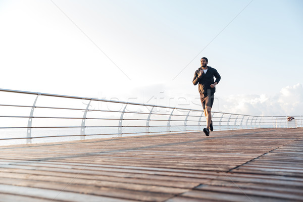 Stock photo: Sportsman listening to music and running in the morning