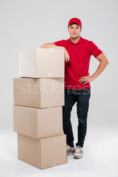 Uśmiechnięty kurier czerwony shirt Zdjęcia stock © deandrobot
