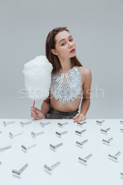 Kobieta bawełny candy posiedzenia tabeli Zdjęcia stock © deandrobot