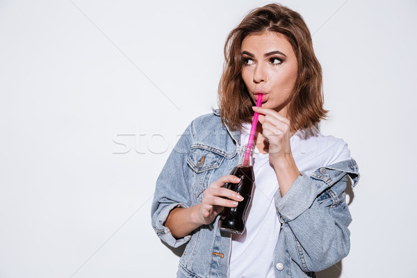 Young woman drinking aerated sweet water. Stock photo © deandrobot