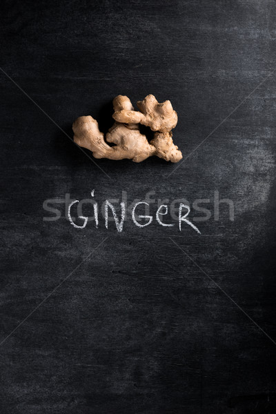 Image of a ginger over dark chalkboard background Stock photo © deandrobot
