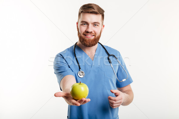 Portrait of handsome doctor in blue coat looking at camera Stock photo © deandrobot