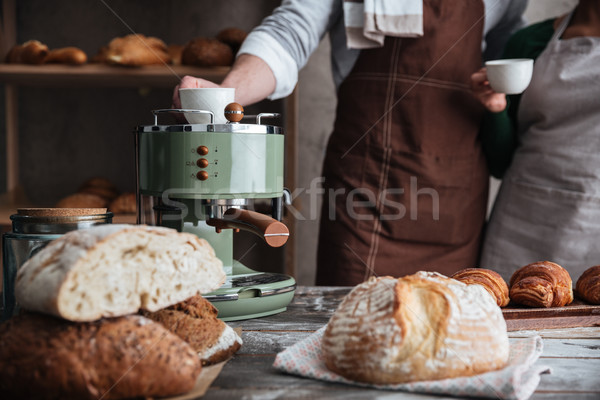 Loving couple bakers drinking coffee. Stock photo © deandrobot