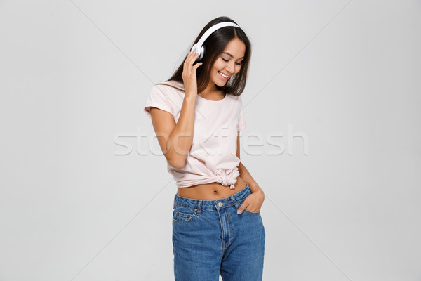 Stock photo: Portrait of a cheerful delighted asian woman in headphones