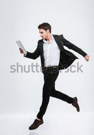 Full length portrait of a smiling handsome businessman Stock photo © deandrobot