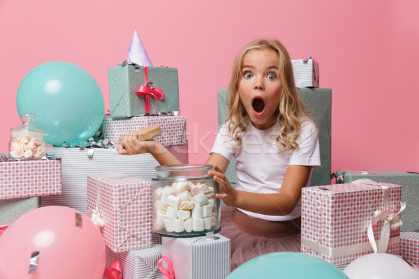 Portrait of a shocked little girl in a birthday hat Stock photo © deandrobot