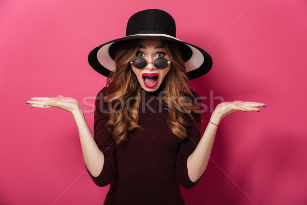 Emotional lady wearing hat and sunglasses Stock photo © deandrobot