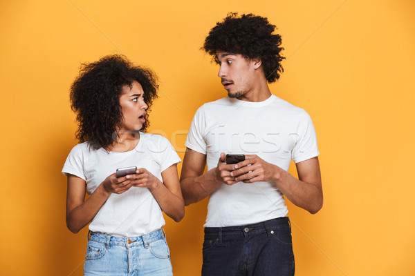 Portrait of a confused afro american couple Stock photo © deandrobot