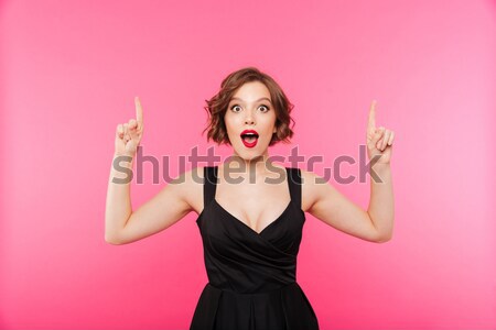 Portret opgewonden jonge vrouw zwempak wijzend vingers Stockfoto © deandrobot