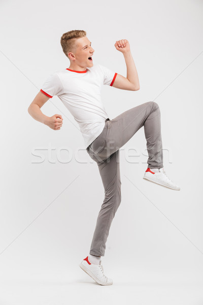 Full length portrait of a cheerful teenage boy Stock photo © deandrobot