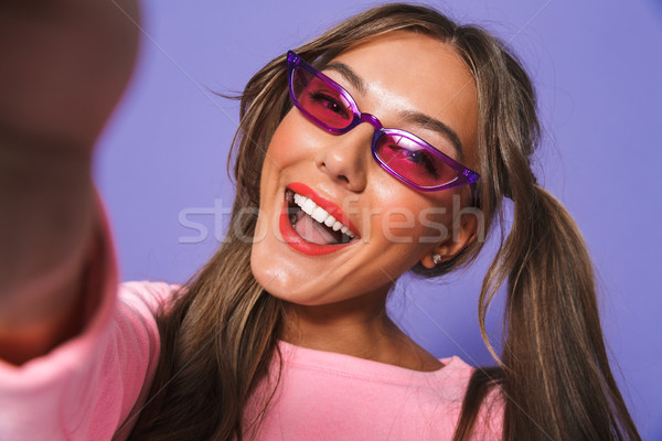 Stock photo: Portrait of a happy young girl in sunglasses