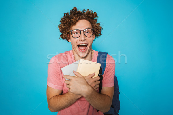 Photo of smart student guy with curly hair wearing glasses and b Stock photo © deandrobot