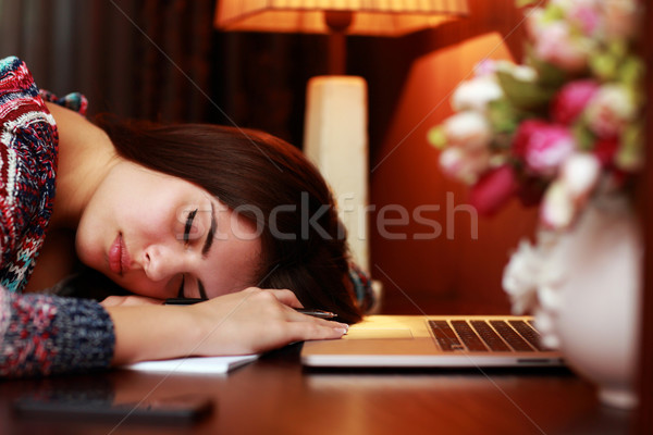 Tired woman sleeping on the table at home Stock photo © deandrobot