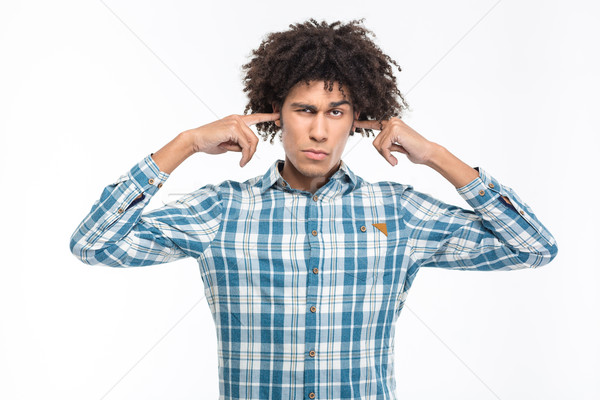 Serious man covering his ears Stock photo © deandrobot