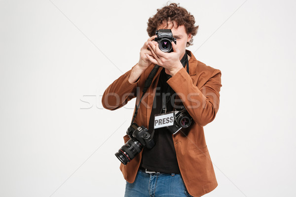 Male reporter making photo on camera Stock photo © deandrobot