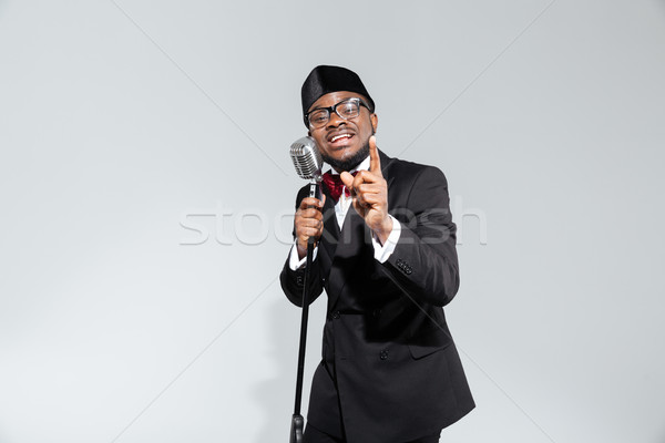 Stock photo: Afro amerian man singing into vintage microphone