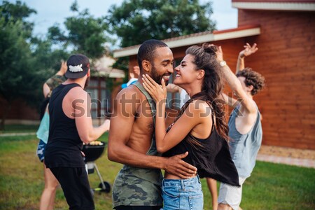 Young cheerful happy teens dancing at the picnic area Stock photo © deandrobot