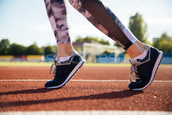 Close up portrait of a female runner feet running Stock photo © deandrobot