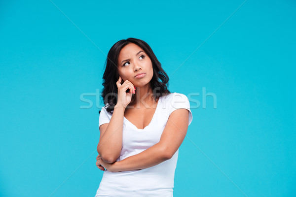 Portrait of a pensive pretty asian girl thinking about something Stock photo © deandrobot