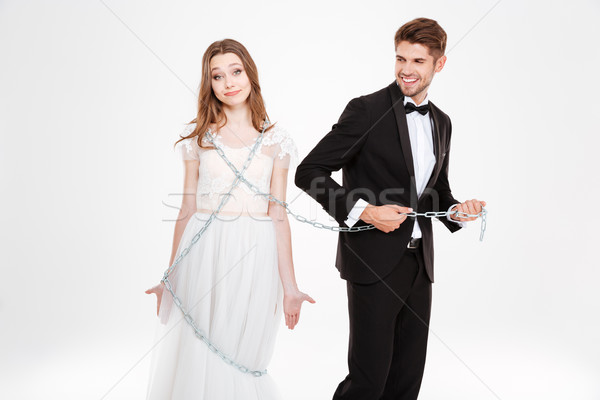 Man catching woman in chaine Stock photo © deandrobot