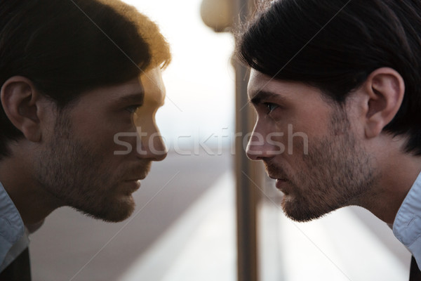 Man in suit looking at mirror Stock photo © deandrobot